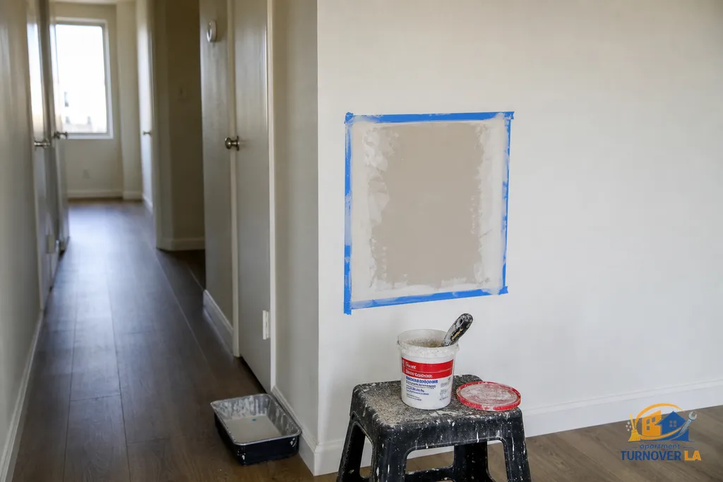 Medium drywall repair in a Koreatown rental hallway with setting compound, clean cutout, and prep for same-day paint