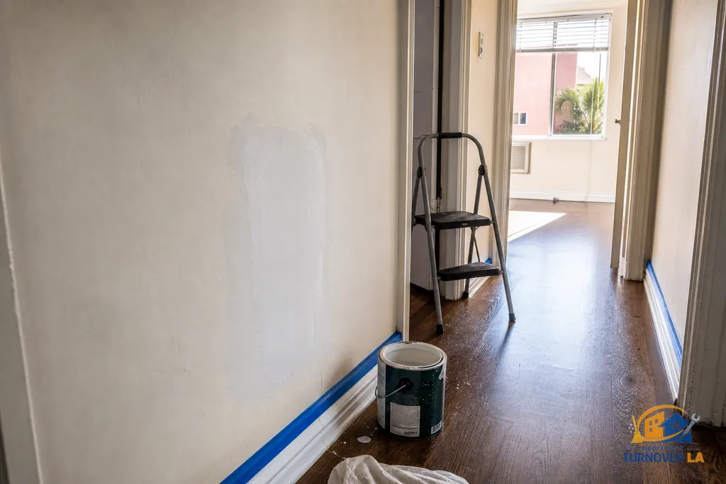 Hallway drywall patch and taped baseboards in a Hollywood apartment, showing texture repair before interior painting