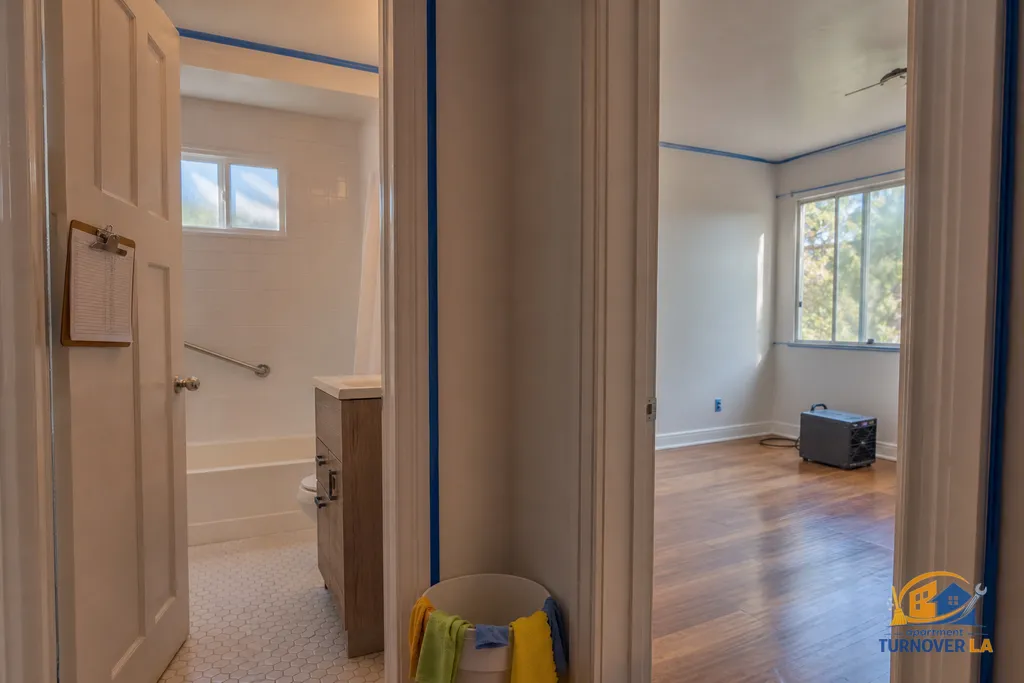 Bathroom and bedroom staged for sequential 30 minute cleaning blocks with labeled supplies, checklist, and prep for odor treatment
