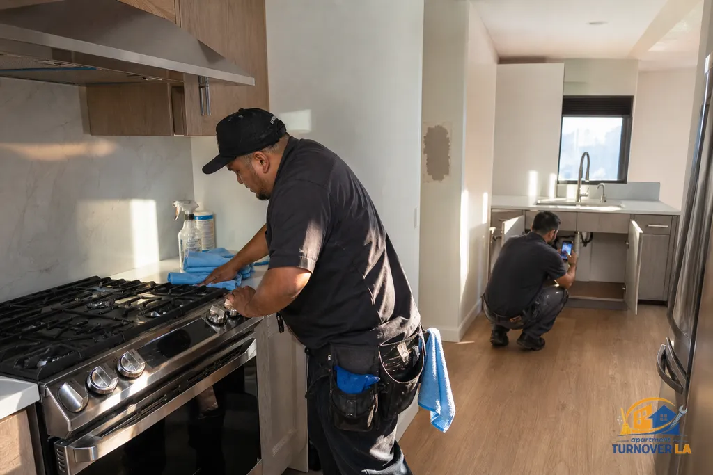 Kitchen turnover details in an LA 1BR, stove cleaning and photo documentation while a nearby drywall patch dries, ready for Make Ready and repairs