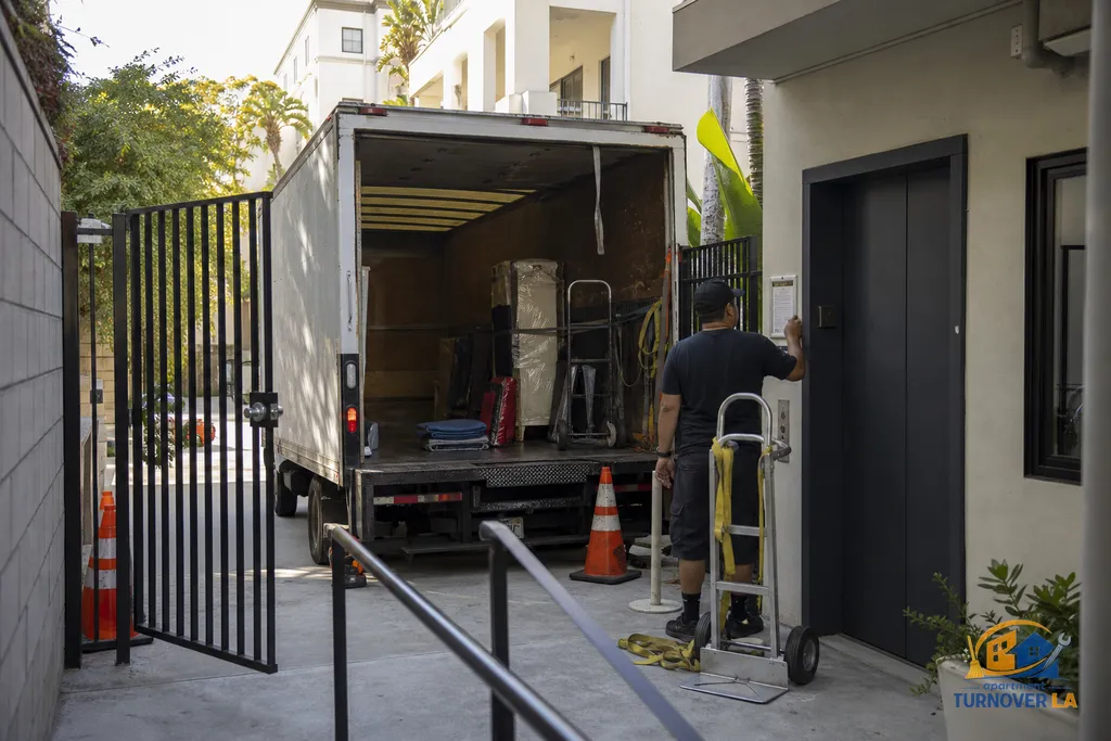 Santa Monica alley access with cones and dolly set for junk haul, showing tight gate and elevator coordination details