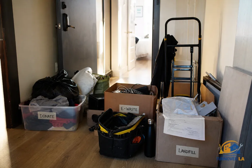 Sorted donation and e-waste piles staged in an LA apartment hallway before a scheduled bulky pickup and private junk haul
